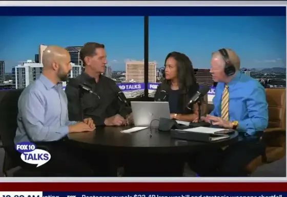 Frame from FOX 10 Talks. From left: Ryan Caracciolo, John Crow and two FOX 10 hosts at a round desk. Crow says: “Let's say it's a million and a half. … But you have a million, 1.1 million thereabouts in tuition from the athletes that are playing there. None of them are on full rides. So you cut enrollment. You cut revenue when you cut the program.”
